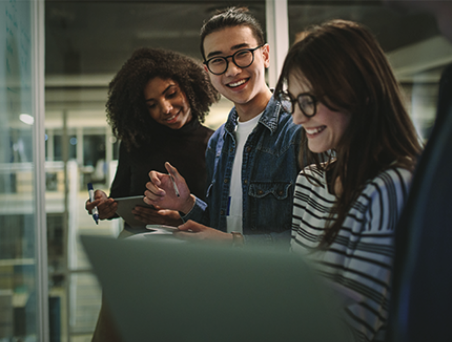 Three researchers collaborate in a laboratory.